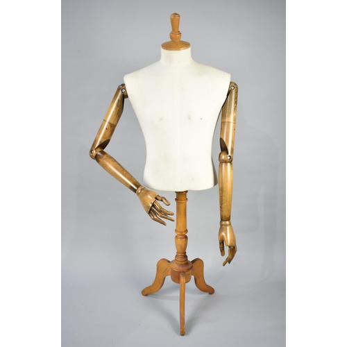 109 - A Dress Makers Dummy with Articulated Wooden Arms on Tripod Stand