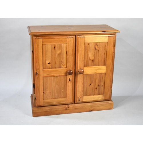 172 - A Modern Pine Side Cabinet with Panelled Doors, 76cms Wide