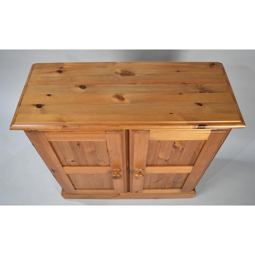 172 - A Modern Pine Side Cabinet with Panelled Doors, 76cms Wide