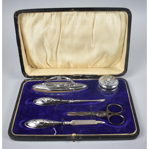 32 - An Edwardian Silver Mounted Manicure Set by The Boots Pure Drug Company, Birmingham Hallmark 1912