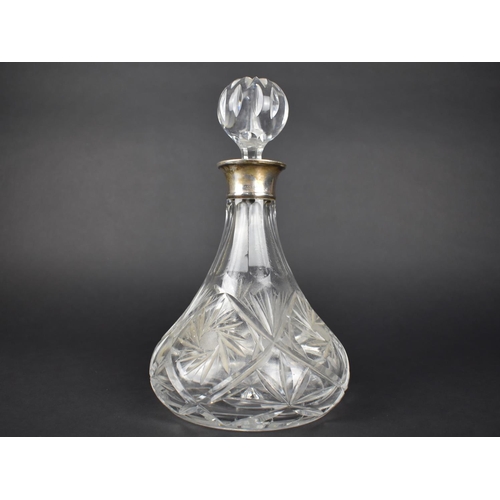 380 - A Cut Glass and Silver Decanter, the Silver Cuff with London Hallmark by Roberts & Dore Ltd