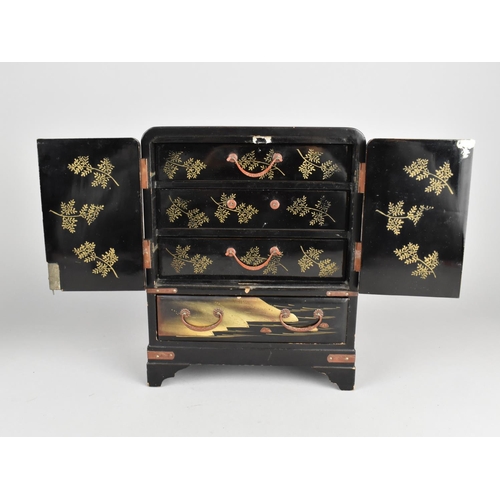 4 - A Small Japanese Lacquered Table Top Collectors Cabinet with Four Long Drawers and Two Panelled Door... 