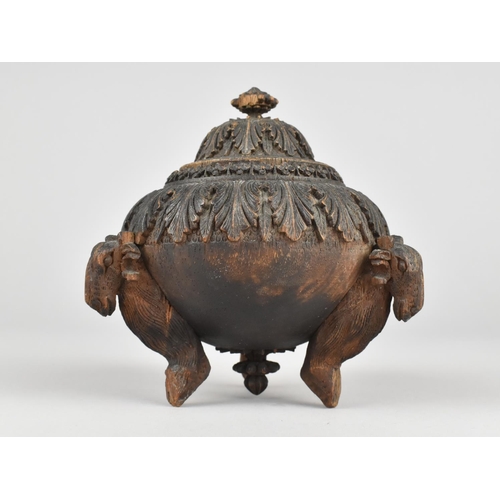 44 - A Carved Indian Wooden Lidded Circular Pot on Three Goat Supports, 9cms Diameter and 11cms High