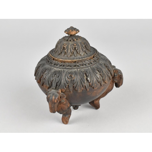 44 - A Carved Indian Wooden Lidded Circular Pot on Three Goat Supports, 9cms Diameter and 11cms High