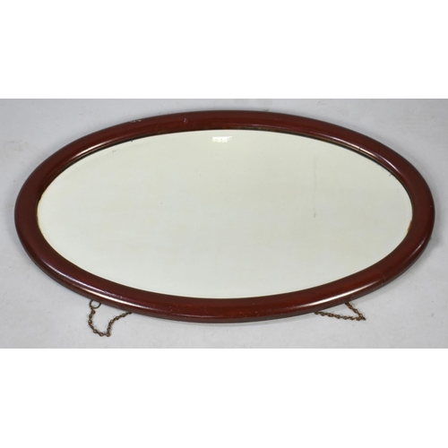 466 - An Oval Wall Hanging Mirror, 74cms Wide