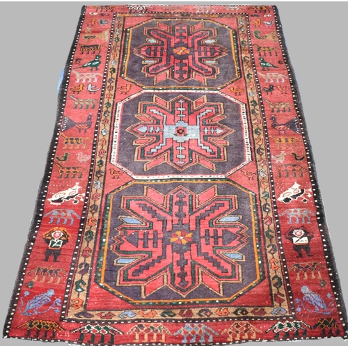 501 - A Patterned Woollen Rug on Red Ground, 230cms by 135cms