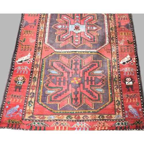 501 - A Patterned Woollen Rug on Red Ground, 230cms by 135cms