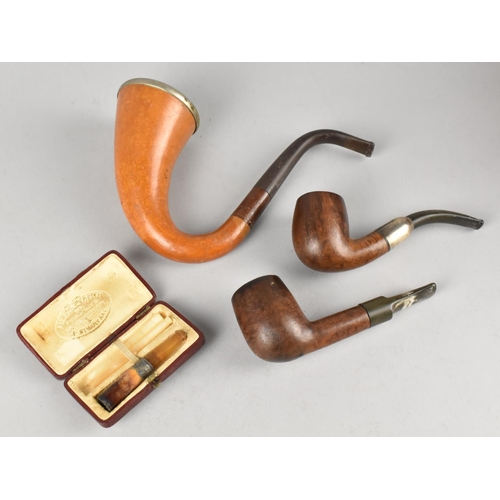 79 - Three Vintage Pipes and a Cased Amber Cheroot Holder by Allen and Rice, Small Briar Pipe with Silver... 