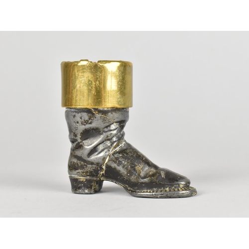 9 - An Interesting Spelter and Brass Novelty Match Holder/Striker in the Form of a Boot, 6cms HIgh