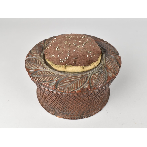 10 - A Late 19th Century Carved Wooden Circular Pin Cushion, 15cms Diameter and 10cms High