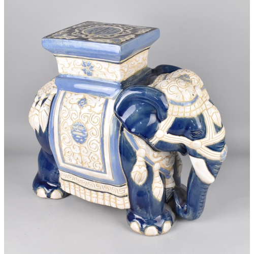 104 - A Large Souvenir Blue and White Glazed Indian Stool in the Form of an Elephant, 42cms High