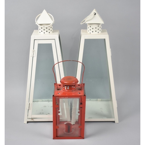 204 - A Pair of White Painted Modern Lanterns and a Red Painted Candle Lantern, Tallest 40cms High