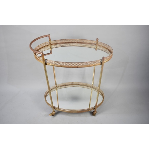 404 - A Mid 20th Century Oval Two Tier Trolley with Mirrored Shelves, Casters in Need of Attention, 75cms ... 