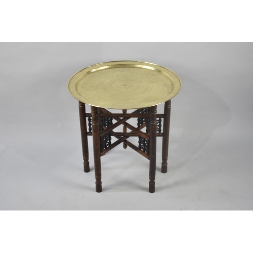 414 - A Late 20th Century Souvenir Brass Topped Benares Tray with Folding Wooden Stand, 57cms Diameter