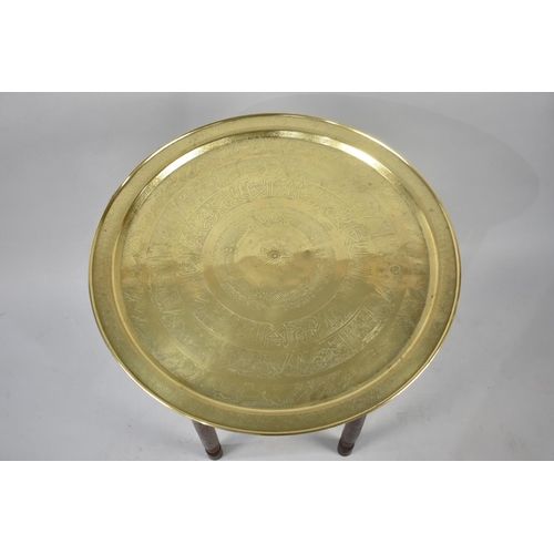 414 - A Late 20th Century Souvenir Brass Topped Benares Tray with Folding Wooden Stand, 57cms Diameter