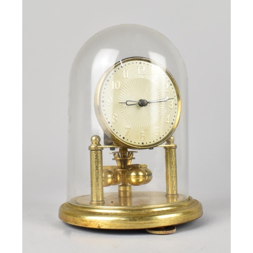 60 - A Small Brass Pillar Clock under Glass Dome, 17cms High