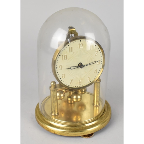 60 - A Small Brass Pillar Clock under Glass Dome, 17cms High