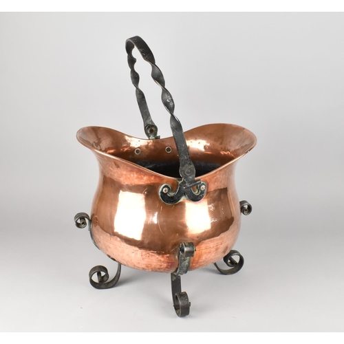 65 - An Ornamental Copper and Wrought Iron Planter in the Form of a Helmet Shaped Coal Scuttle with Four ... 