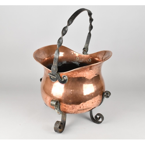 65 - An Ornamental Copper and Wrought Iron Planter in the Form of a Helmet Shaped Coal Scuttle with Four ... 