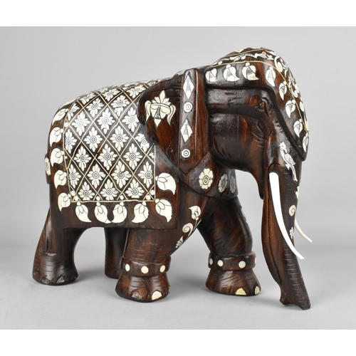 86 - A Carved Wooden Indian Elephant with Faux Ivory Inlay, 27cms Long