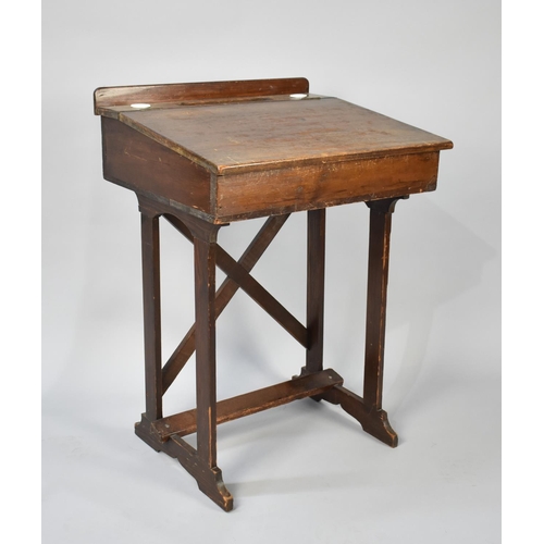 34 - An Early 20th Century School Desk with hinged Sloping Lid to Galleried Back having Inset Grooves and... 