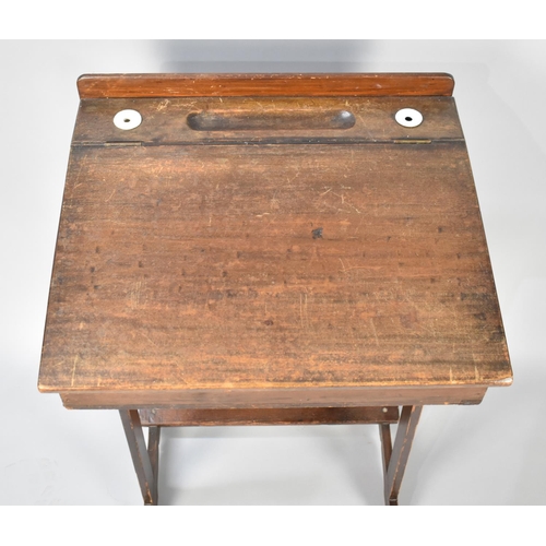 34 - An Early 20th Century School Desk with hinged Sloping Lid to Galleried Back having Inset Grooves and... 