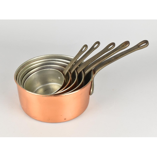 83 - A Set of Five Graduated Copper Saucepans