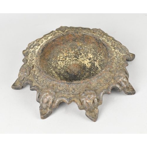 12 - A 19th Century Cast Iron Circular Bowl with Eight Scrolled Mask Head Feet, Overall Diameter 22cms