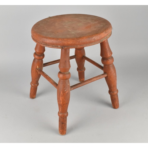 130 - A Vintage Orange Painted Circular Seated Four Legged Stool, 26cms Diameter and 31cms High