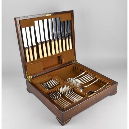 131 - An Edwardian Oak Cased Canteen of Cutlery, Incomplete