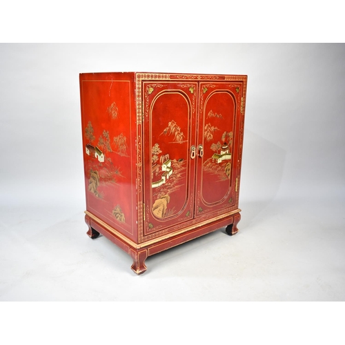 139 - An Oriental Lacquered Cabinet with Panelled Doors, Gilt Decoration, 57cms Wide and 74cms High