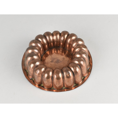 33 - A 19th Century Circular Copper Jelly Mould, 14cms Diameter and 4.5cms High