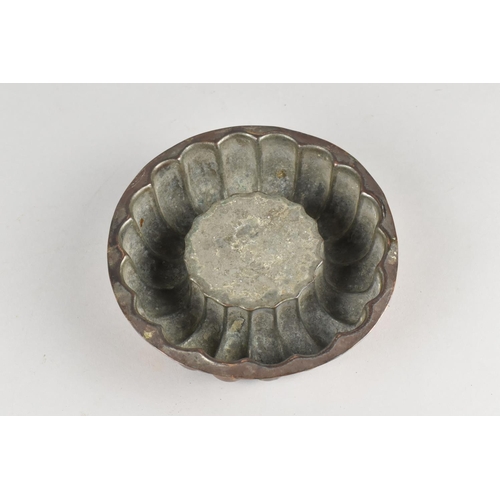 33 - A 19th Century Circular Copper Jelly Mould, 14cms Diameter and 4.5cms High