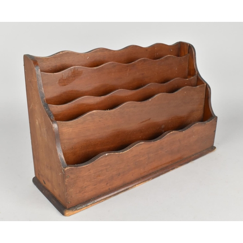 4 - A Late Victorian/Edwardian Mahogany Four Division Stationery Rack, 32cms Wide and 20ms High