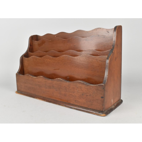 4 - A Late Victorian/Edwardian Mahogany Four Division Stationery Rack, 32cms Wide and 20ms High