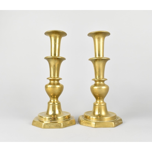 42 - A Pair of 19th Century Brass Candlesticks with Pushers on Octagonal Bases, 25cms High