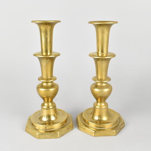 42 - A Pair of 19th Century Brass Candlesticks with Pushers on Octagonal Bases, 25cms High