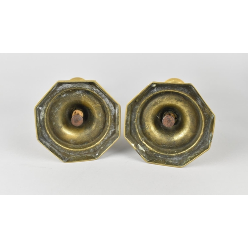 42 - A Pair of 19th Century Brass Candlesticks with Pushers on Octagonal Bases, 25cms High