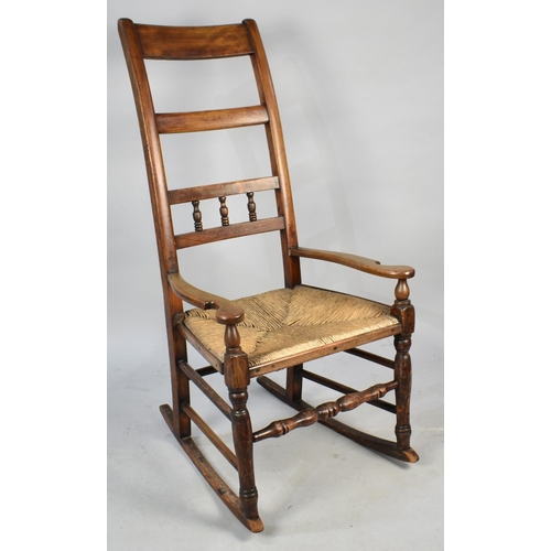 523 - A Late Victorian/Edwardian Rush Seated Ladder Back Rocking Chair