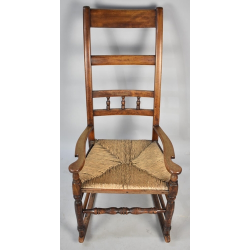 523 - A Late Victorian/Edwardian Rush Seated Ladder Back Rocking Chair