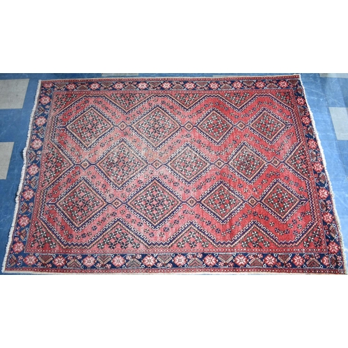 524 - A Patterned Rug on Red Ground, 213x152cms