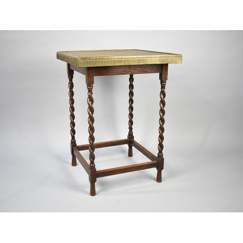 65 - An Edwardian Oak Barley Twist Square Topped Games Table with Hammered Brass Cover Decorated in the I... 