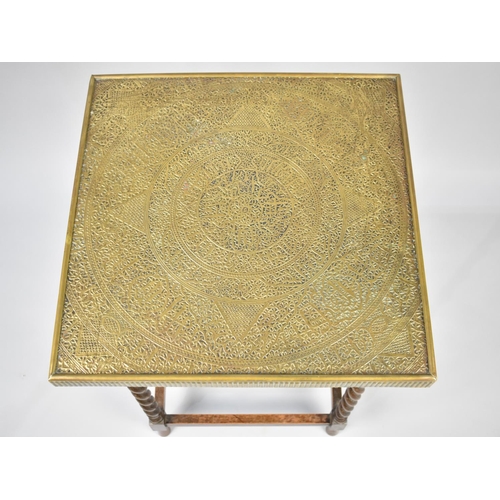 65 - An Edwardian Oak Barley Twist Square Topped Games Table with Hammered Brass Cover Decorated in the I... 