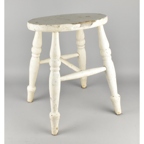 84 - A White Painted Oval Vintage Four Legged Stool, 36.5cms Wide and 46cms High