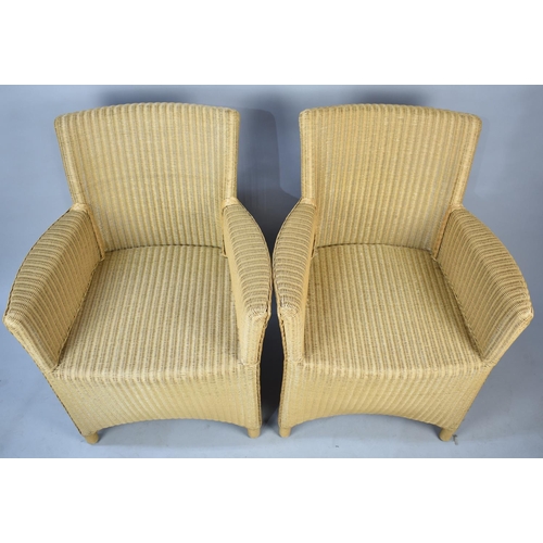 555 - A Pair of Modern Lloyd Loom Armchairs