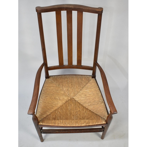 565 - An Edwardian Mahogany Framed Rush Seated Ladies Nursing Armchair