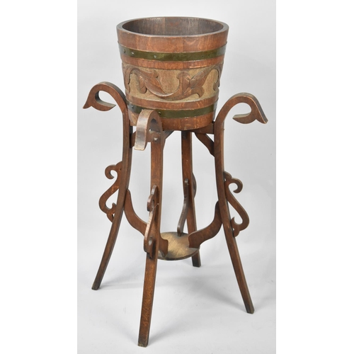 109 - An Arts and Crafts Influenced Oak Coopered Planter with Carved Body set on Tripod Stand with Scrolle... 