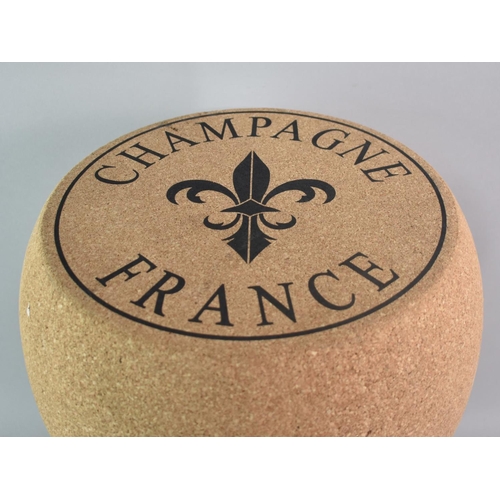 114 - A Novelty Stool in the Form of a Champagne Cork, 35cms Diameter and 50cms High