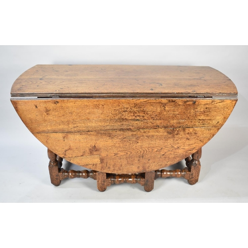 502 - An Early 18th Century Oak Drop Leaf Gate Leg Dining Table with Oval Top, 135cms Long