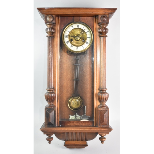 323 - An Early 20th Century Oak Cased Vienna Style Wall Clock, with pendulum and Key, the Brass Face with ... 